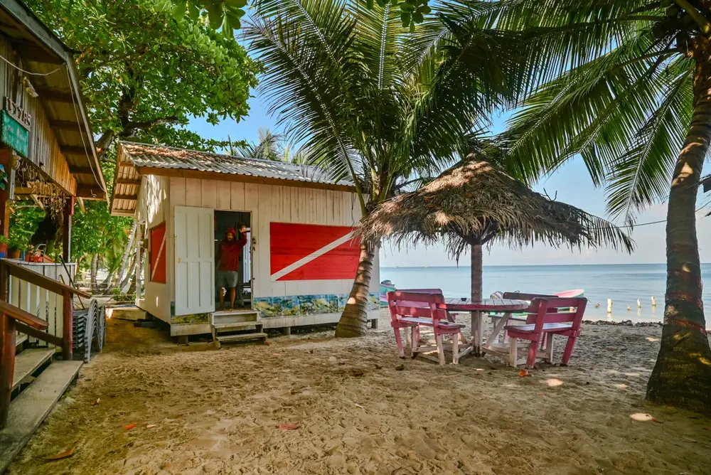 The on-site dive shop on the sand, with the dive flag painted on its wall